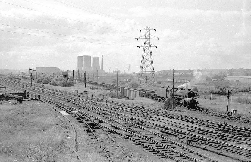 An unidentified ex-LMS 8F 2-8-0 is leaving Washwood Heath sidings with a freight train in 1962 viewed from Bromford Lane bridge