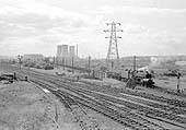 An unidentified ex-LMS 8F 2-8-0 is leaving Washwood Heath sidings with a freight train in 1962 viewed from Bromford Lane bridge