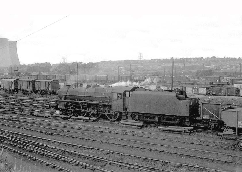 Viewed from the headshunt  in 1965, an unidentified ex-LMS Class 5 4-6-0 locomotive proceeds on a westbound coal train