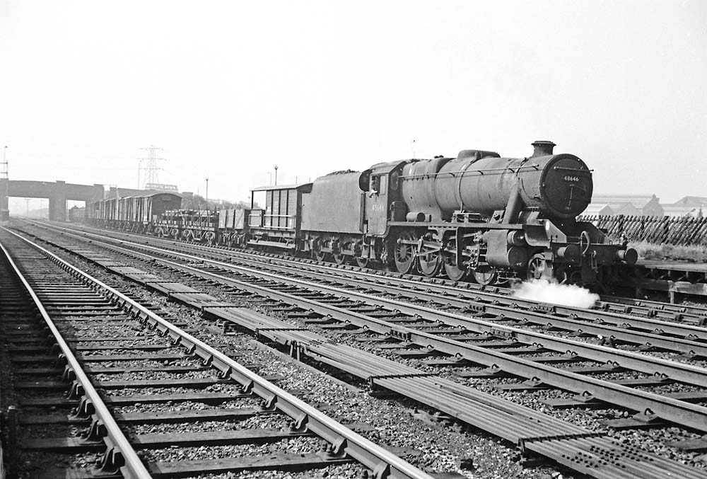 Ex-LMS 8F 2-8-0 No 48646 passes through Bromford Bridge at the head of an up mixed freight service