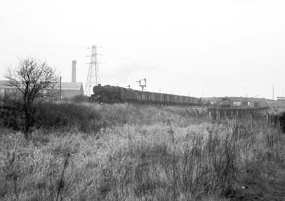 Another view of an unidentified ex-LMS 8F 2-8-0 locomotive heading an up mixed freight service