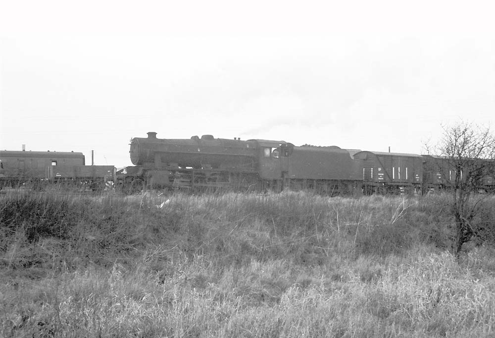 An unidentified and very dirty ex-LMS 8F 2-8-0 locomotive approaches Bromford Bridge with an up mixed freight service