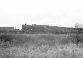 An unidentified and very dirty ex-LMS 8F 2-8-0 locomotive approaches Bromford Bridge with an up mixed freight service