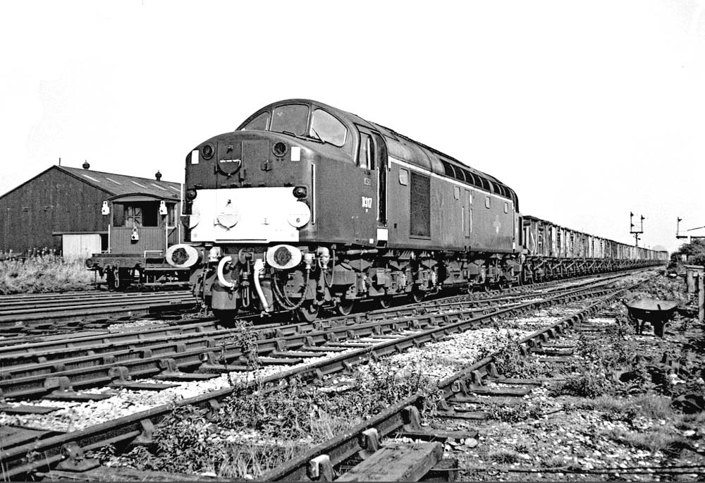 British Railways' English Electric Type 4 1Co-Co1 D317 approaches the station on a down service of coal empties