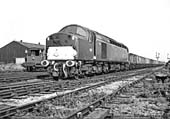 British Railways' English Electric Type 4 1Co-Co1 D317 approaches the station on a down service of coal empties