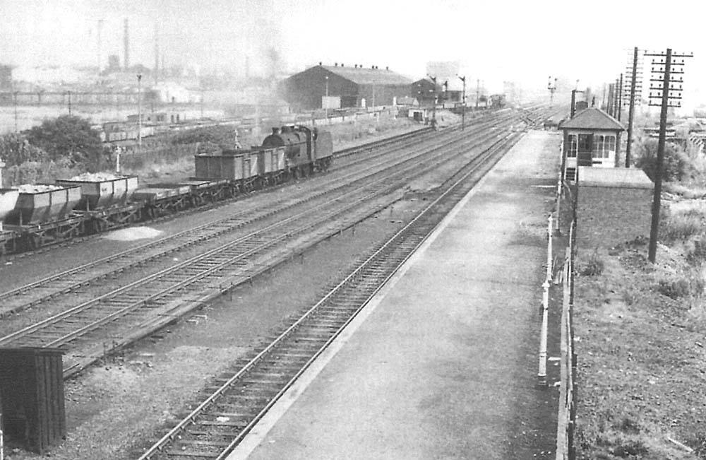 Looking  towards Water Orton from the down platform with ex-LMS 4F 0-6-0 No 44180 running tender first on an up goods service