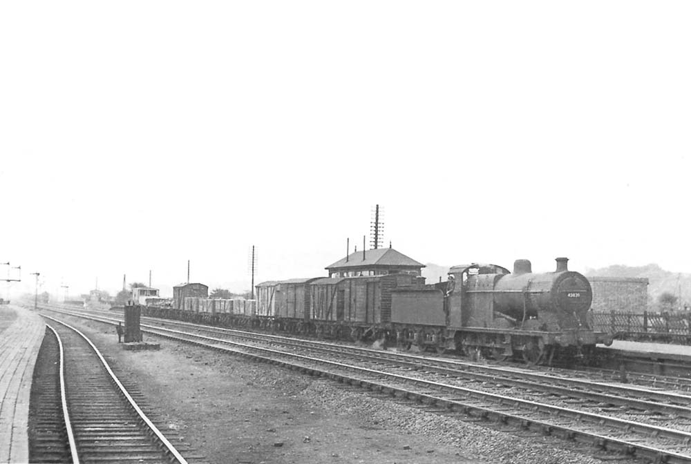 Ex-LMS 0-6-0 4F No 43835 is seen at the head of a down Class H goods train passing through Bromford Bridge station on 30th August 1952