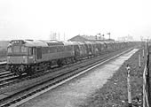 View of D7624 at the head of a freight train passing through Bromford Bridge station after it closed to normal passenger services