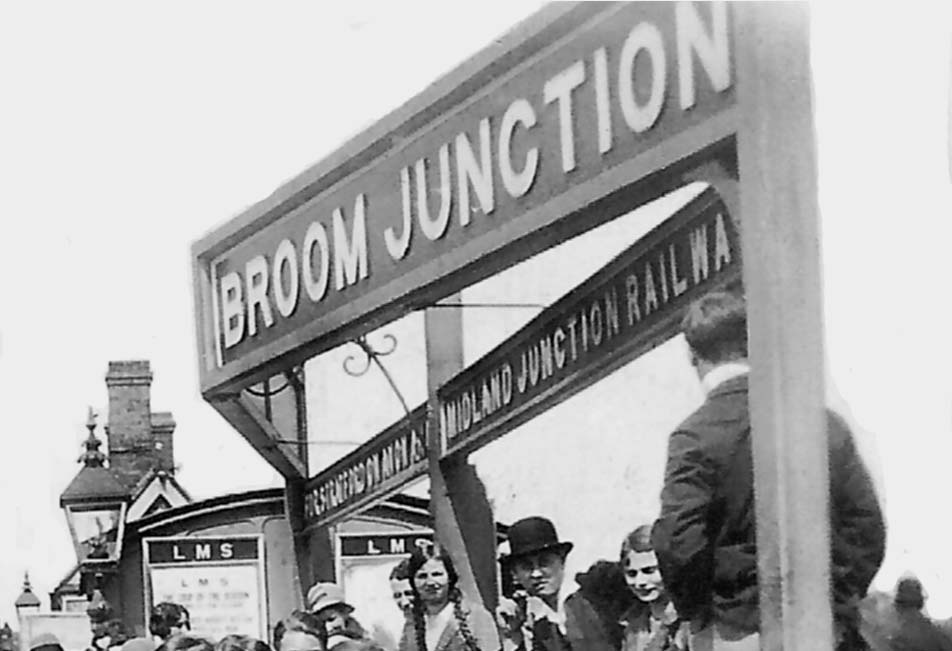 Close up showing the station's name board with a separate reference to the Stratford Midland Junction Railway