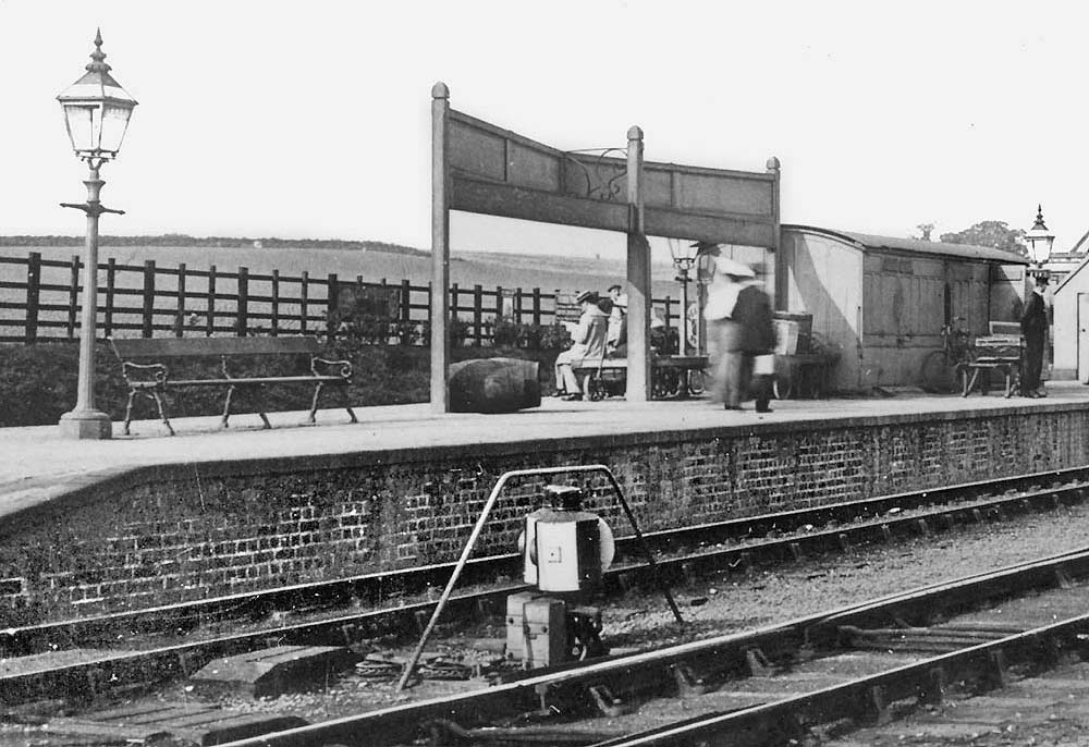Close up showing the rear of the MR's angled two-faced station name board and its central ornate supporting bracket