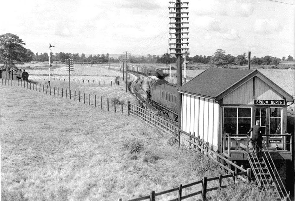 Broom North signal box with the signalman re-entering his box after exchanging the tokens with the Ashchurch bound train