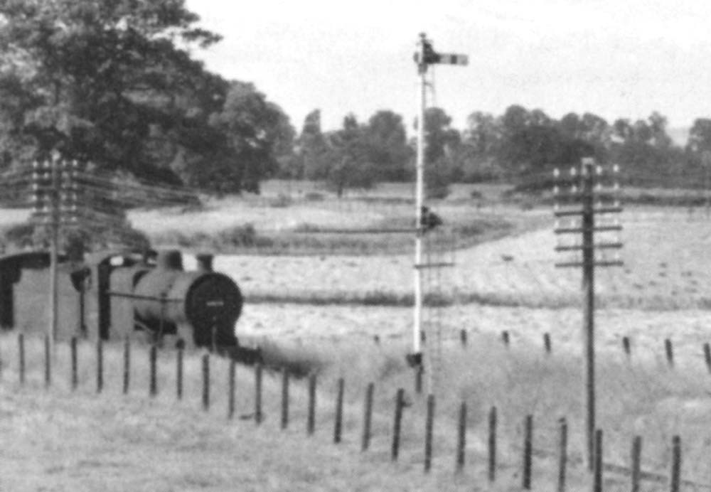 Close up of  an unidentified ex-LMS 4F 0-6-0 standing at the head of a Stratford upon Avon train waiting for the right of way