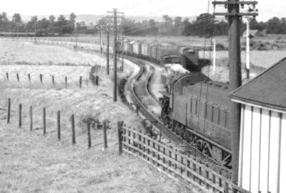 Close up of an unidentified ex-LMS 2-6-0 at the head of an Ashchurch train as it passes over the junction