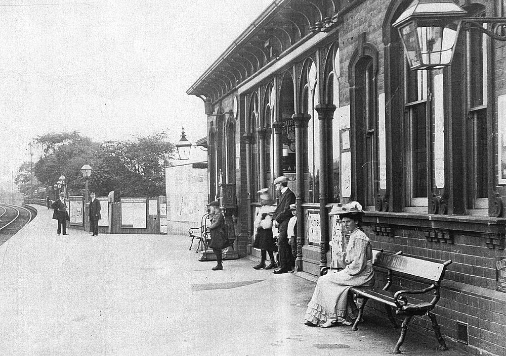 Close up of Camp Hill station's up platform with the main ornate brick built passenger building on the right