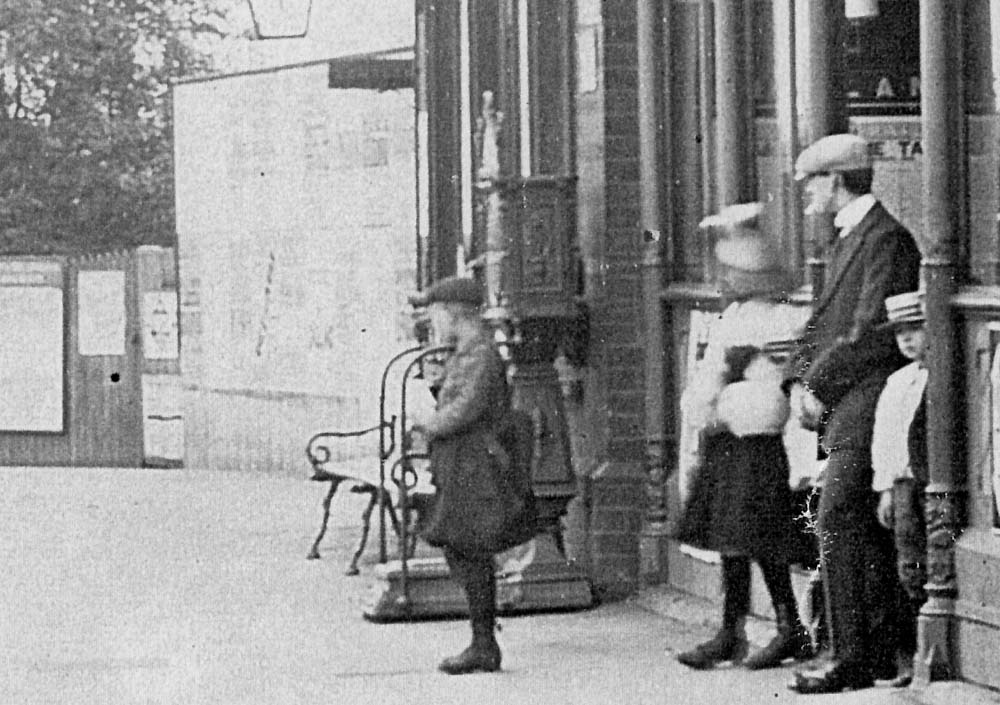 Close up showing the entrance to the main station building and the luggage weighing machine located on the platform