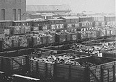 Close up showing open wagons inthe foreground and covered wagons adjacent to the warehouse
