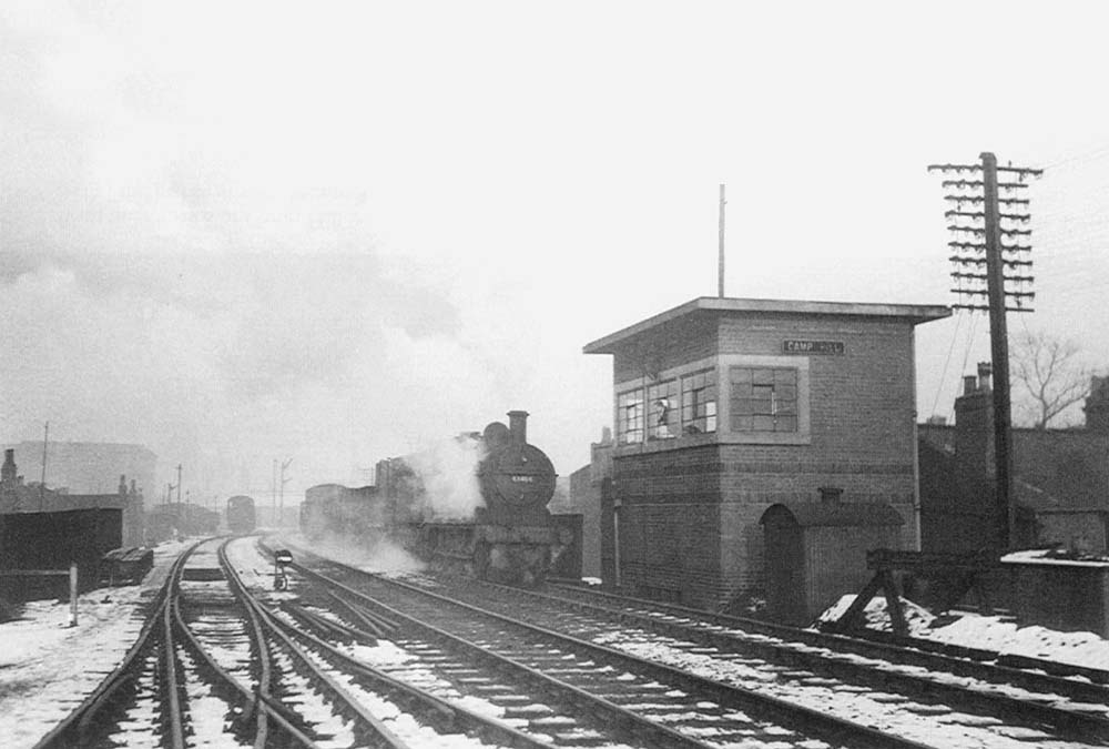 Ex-MR 0-6-0 3F No 43464 is seen passing Camp Hill signal box on a Class H through freight train in 1953