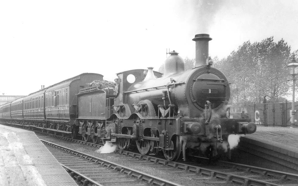 Ex-Midland Railway 1P 2-4-0 No 1 stands at the up platform on a Birmingham to Derby local train on 3rd June 1925