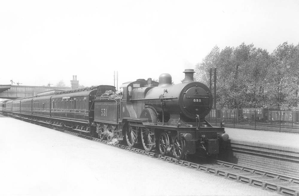 Ex-MR 2P 4-4-0 No 531 passes through the station on an up express service on 3rd June 1925