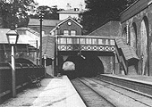 Close up showing the tunnel and the lower quadrant signal suspended from beneath the passenger footbridge