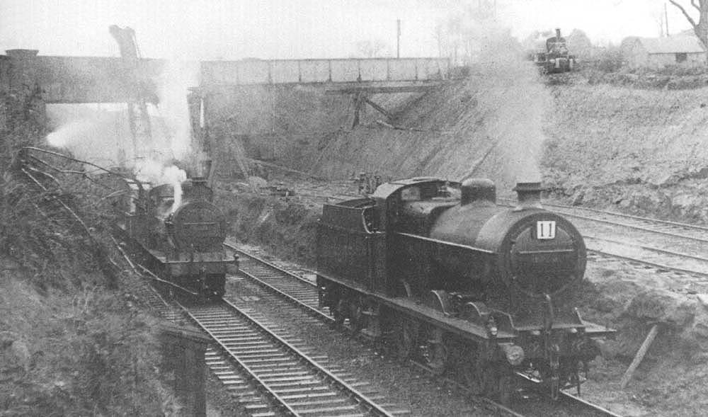 An unidentified ex-MR 3F 0-6-0 locomotive and an LMS 4F 0-6-0 locomotive are being employed on works trains