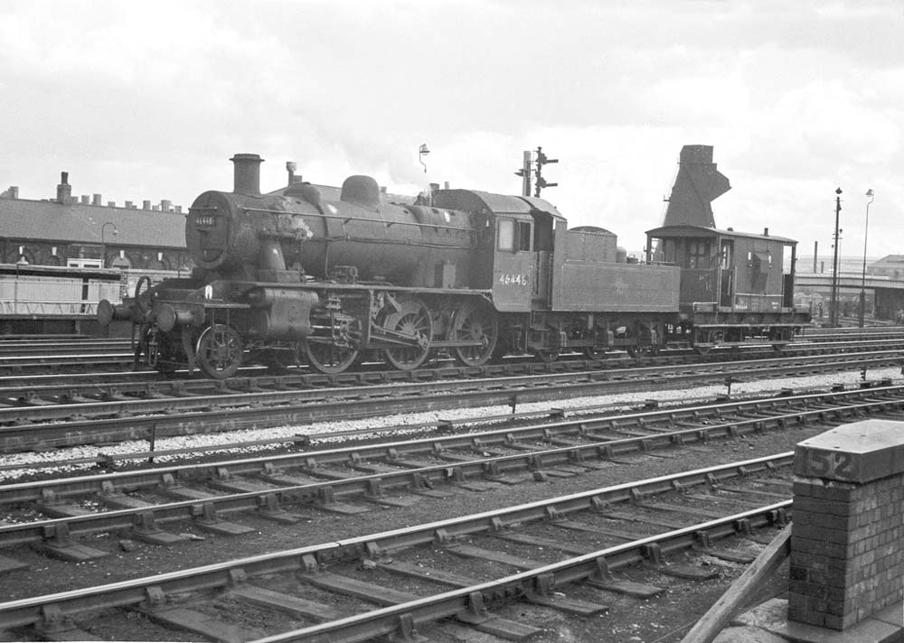 British Railways built Ivatt 2MT 2-6-0 No 46448 is seen with brake van in tow as it passes Saltley shed