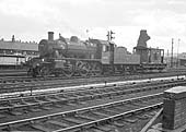 British Railways built Ivatt 2MT 2-6-0 No 46448 is seen with brake van in tow as it passes Saltley shed