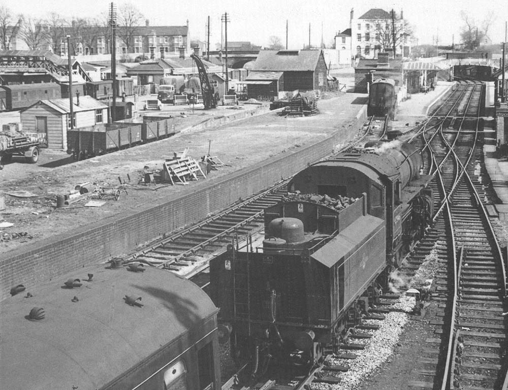 LMS 2-6-0 Ivatt Mogul No 43046 is about to couple to the train it has worked in from Birmingham