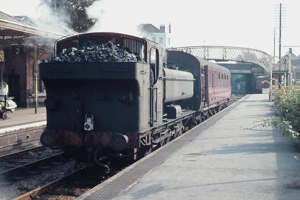 An unidentified ex-GWR 0-6-0PT stands at Evesham with a single coach on a down service from New Street to Ashchurch in October 1962