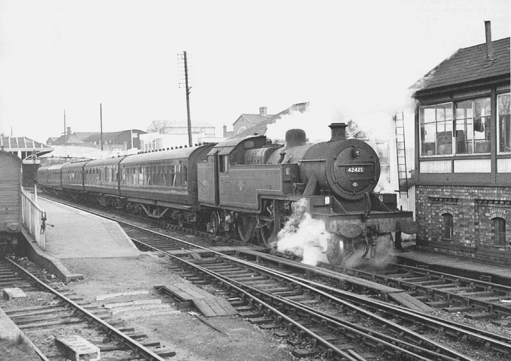 LMS 4P 2-6-4T No 42421 stands at the head of a down train comprised of Period III LMS coaching stock