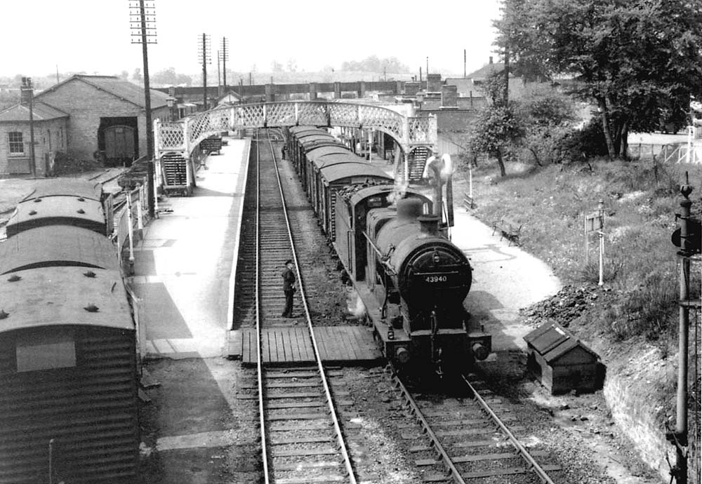 Ex-MR 4F 0-6-0 No 43940 is seen on a nine van 'Beckford' working with the train						set to reverse into the sidings
