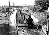 Ex-MR 4F 0-6-0 No 43940 is seen on a nine van 'Beckford' working with the train						set to reverse into the sidings