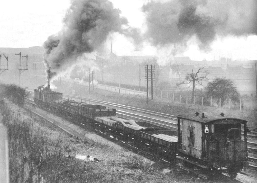 An unidentified ex-MR 3F 0-6-0 runs tender first towards Halesowen Junction with a freight train on 9th January 1960