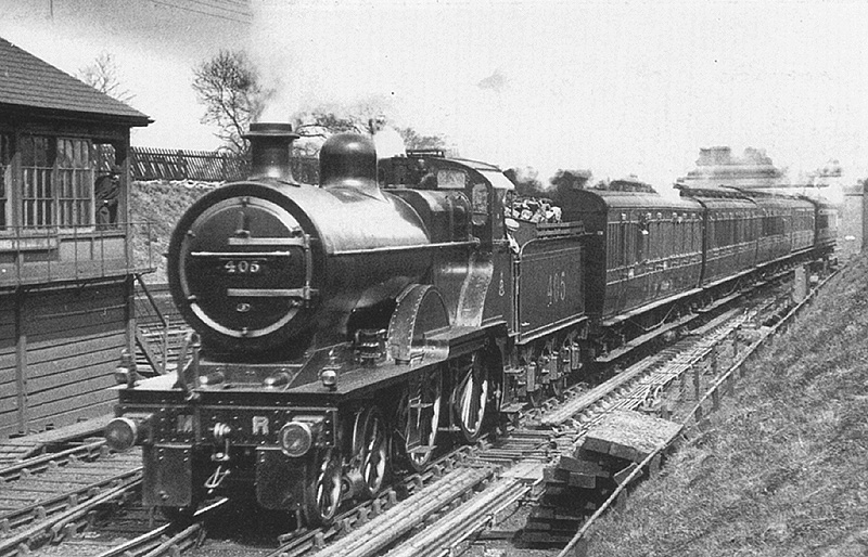 Midland Railway Johnson 2P 4-4-0 No 405 is seen passing Halesowen Junction Signal Box whilst at the head of a Bristol Express