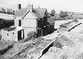 View showing the abandoned station building sometime after closure of the line with some demolition evident