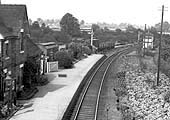 Close up showing Harvington station's goods yard with a variety of vehicles stabled on the siding