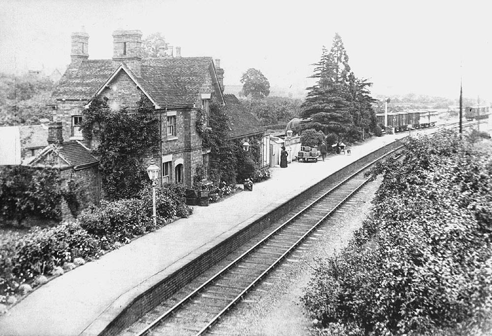 An Edwardian view of the station showing the decorative flowerbeds and ivy grown to soften the hardness of the station structure