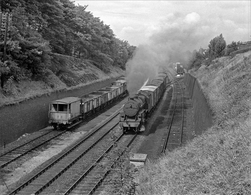 Ex-LMS 2-6-0 'Hughes Crab' No 42763 is working hard as it climbs past Hazelwell goods yard on 20th July 1957