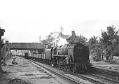 BR Standard 2-10-0 9F No 92052 is seen at the head of a long goods train of empty open wagons in 1961