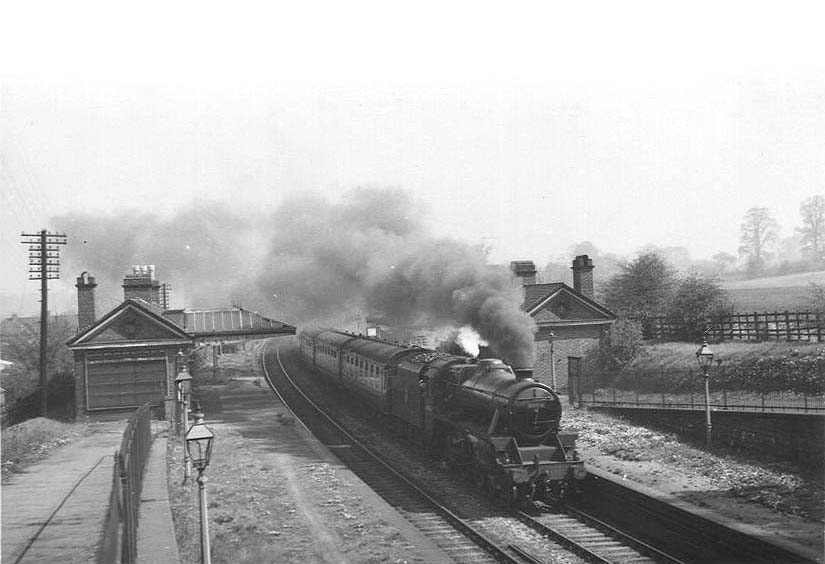 Ex-LMS 4-6-0 Black 5 No 44814 at the head of an express passes through the station on 5th May 1953