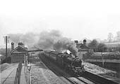 Ex-LMS 4-6-0 Black 5 No 44814 at the head of an express passes through the station on 5th May 1953