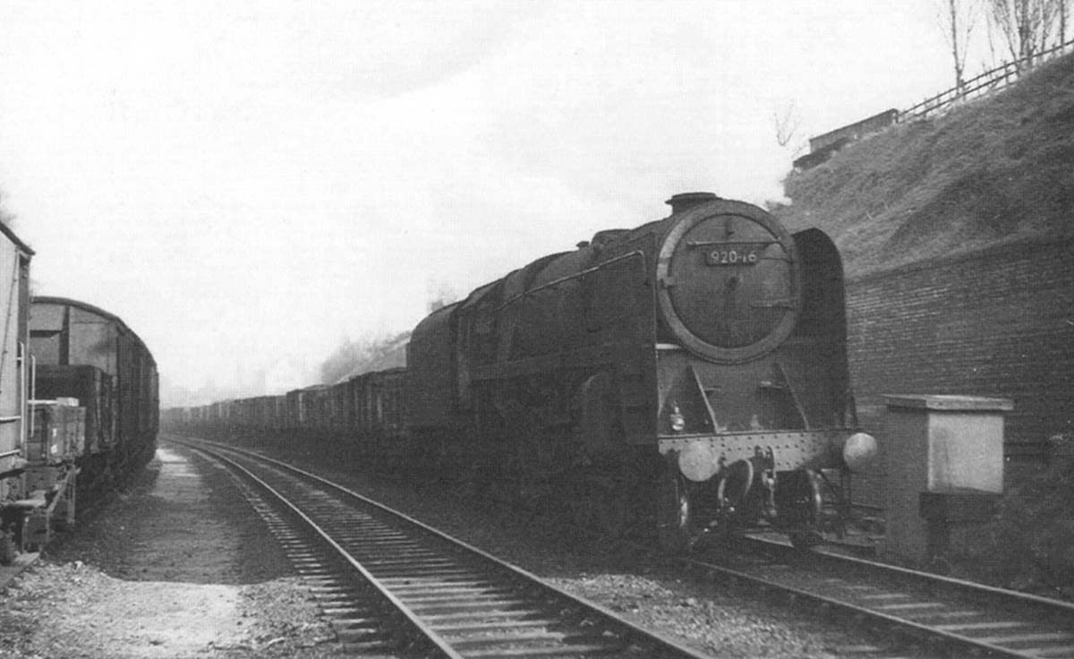 British Railways 2-10-0 9F No 92046 is seen passing Hazelwell's down refuge siding whilst at the head of a Class J train of empty wagons