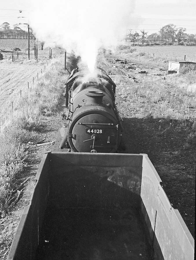 Ex LMS 4-6-0 'Stanier Black Five' No 44828 is seen propelling a rake of wagons towards Baddesley Colliery