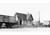 Looking from the down platform across to the station building whilst mineral wagons stand on the down line on 24th April 1952