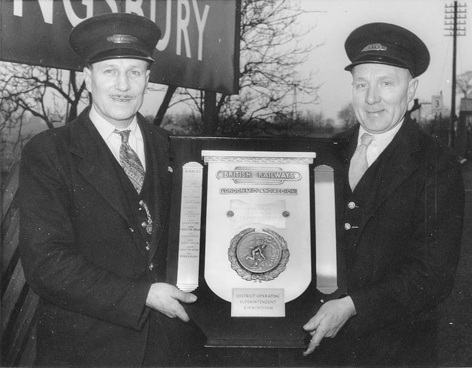 Kingsbury Station Master George Morgan and porter, Joe Day, are seen holding the shield for winning the 'Best Kept Station Garden' competition in 1960