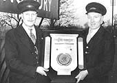 Station Master George Morgan and porter, Joe Day, hold the shield for the 'Best Kept Station Garden' competition