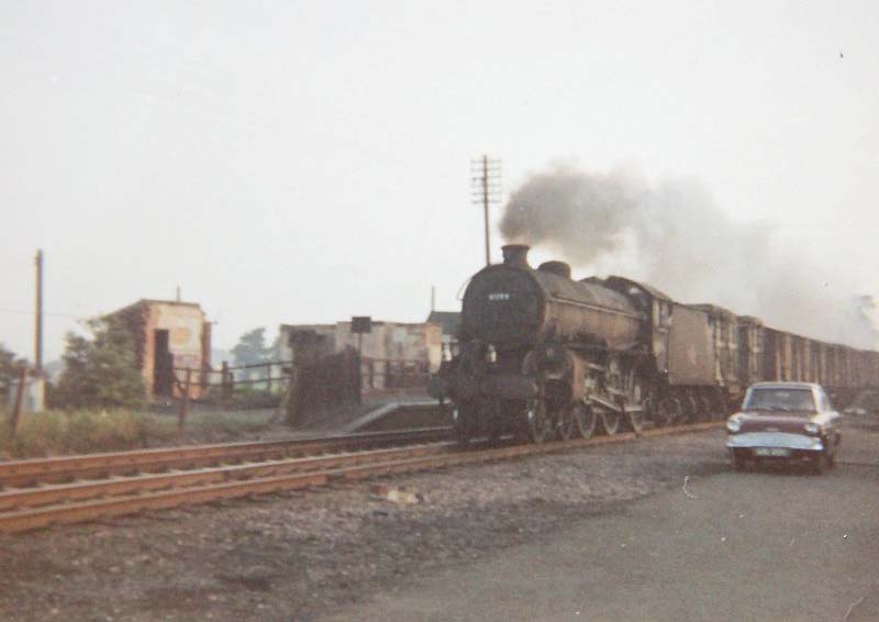 An ex-LNER B1 4-6-0 locomotive is seen passing through Kingsbury station whilst at the head of an up fully fitted express freight train