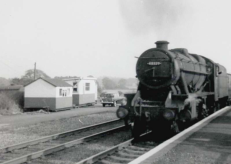 Ex-LMS 8F 2-8-0 No 48339 passes Kingsbury station's temporary accommodation whilst at the head of a Class J mineral train