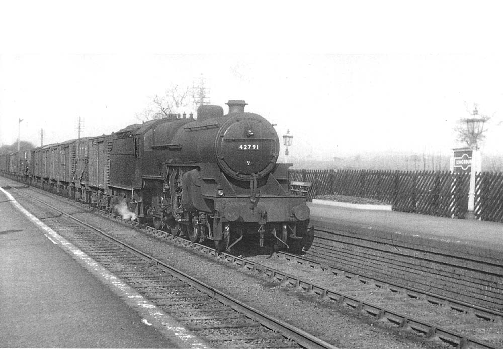 Ex-LMS 6P5F 2-6-0 'Crab' No 42791 is seen at the head of a Derby to Birmingham Class 'D' express freight service as it passes through the station on 8th March 1956