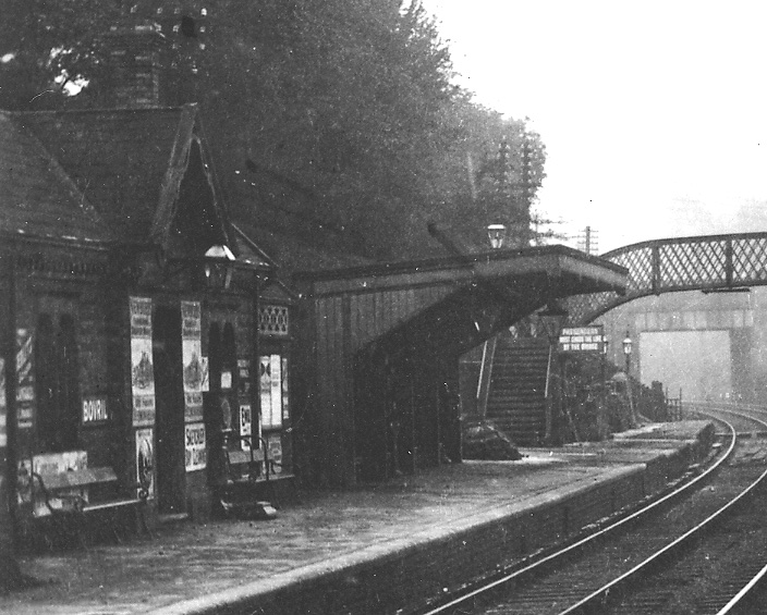 Close up showing the plethora of posters covering the facade of the up platform building and the weighing machine